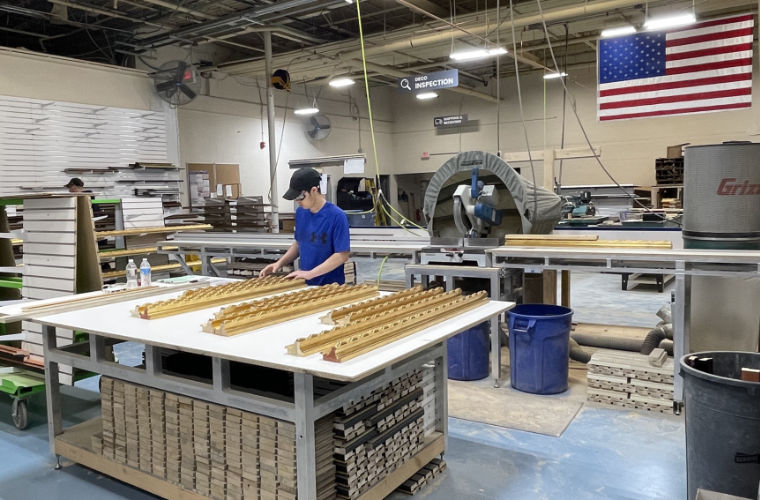 Warehouse worker cutting frames
